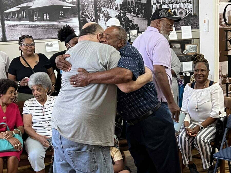 Family members reunited, hugging to greet one another.