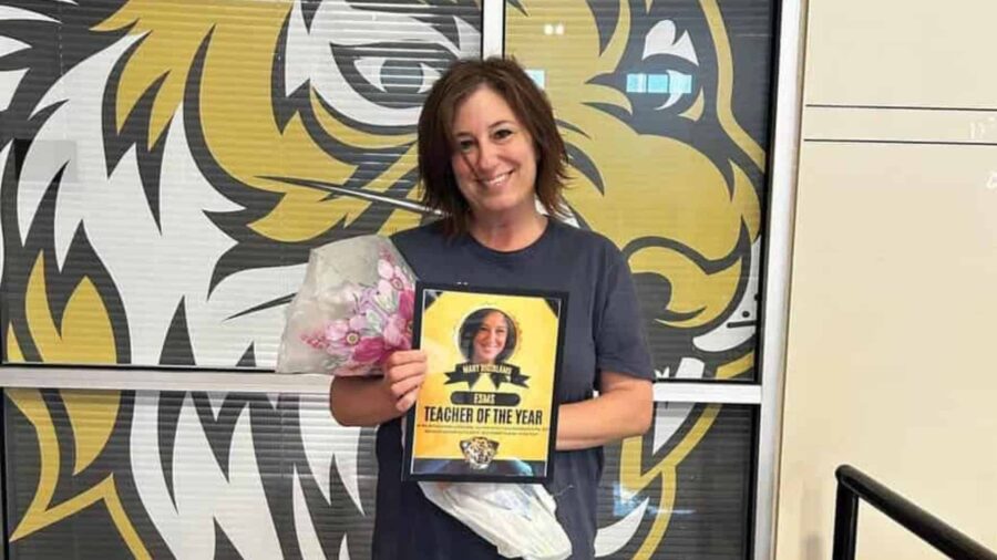 Mary DiGirlamo is a tiger through-and-through holding her Teacher of the Year award.