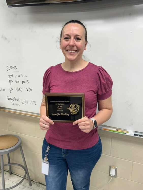 Harding proudly holds her award after being honored and celebrated by Excelsior Springs High School.